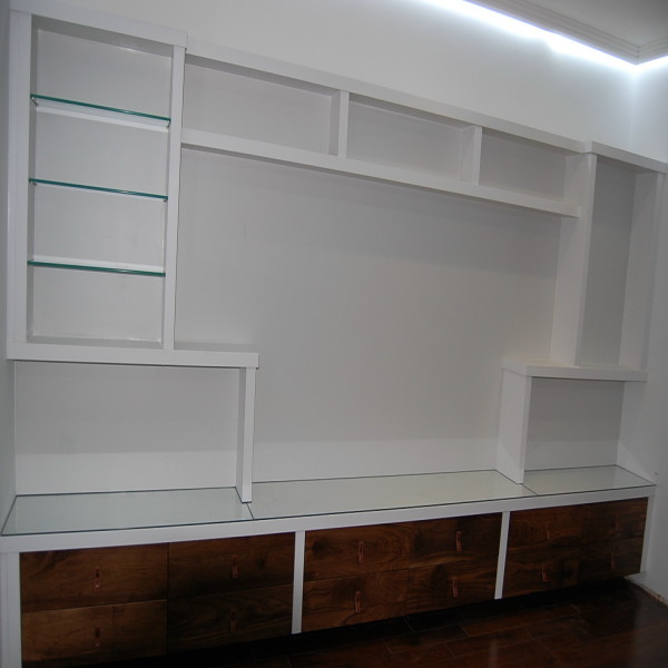 white painted television and display unit with glass shelves and walnut drawers